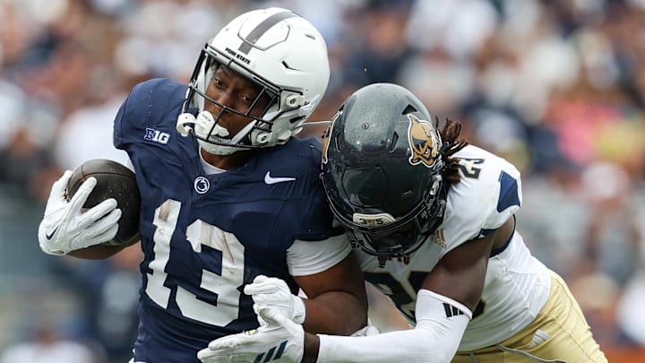 Sep 6, 2025; University Park, Pennsylvania, USA; Penn State Nittany Lions running back Kaytron Allen (13) runs with the ball before being pushed out of bounds by Florida International Panthers defensive back Jessiah McGrew (23) during the first quarter at Beaver Stadium. Mandatory Credit: Matthew O'Haren-Imagn Images