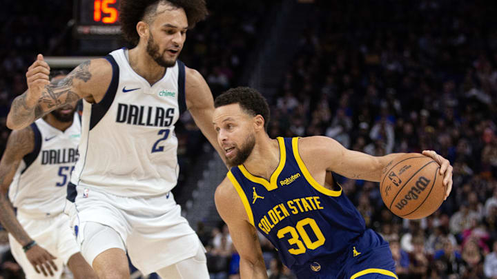 Dec 30, 2023; San Francisco, California, USA; Golden State Warriors guard Stephen Curry (30) drives past Dallas Mavericks center Dereck Lively II (2) during the fourth quarter at Chase Center. Mandatory Credit: D. Ross Cameron-Imagn Images