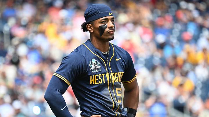 Jun 16, 2026; Omaha, NE, USA;  West Virginia Mountaineers right fielder Armani Guzman (5) waits for a call for a play under review in the game against the Troy Trojans during the fourth inning at Charles Schwab Field. Mandatory Credit: Steven Branscombe-Imagn Images