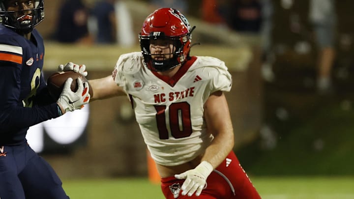 Sep 22, 2023; Charlottesville, Virginia, USA; Virginia Cavaliers wide receiver Malachi Fields (8) catches a pass as North Carolina State Wolfpack linebacker Caden Fordham (10) defends during the fourth quarter at Scott Stadium. Mandatory Credit: Geoff Burke-Imagn Images
