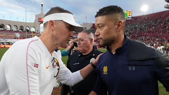Nov 30, 2024; Los Angeles, California, USA; Southern California Trojans head coach Lincoln Riley and Notre Dame Fighting Irish head coach Marcus Freeman shake hands after the game at United Airlines Field at Los Angeles Memorial Coliseum. Nov 30, 2024; Los Angeles, California, USA; Southern California Trojans head coach Lincoln Riley and Notre Dame Fighting Irish head coach Marcus Freeman shake hands after the game at United Airlines Field at Los Angeles Memorial Coliseum.