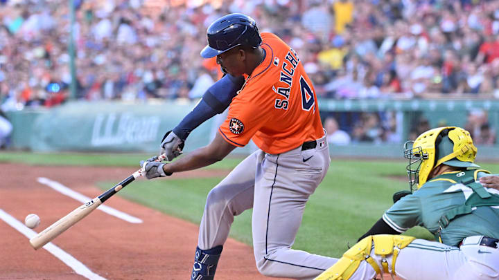 Aug 1, 2025; Boston, Massachusetts, USA; Houston Astros left fielder Jesus Sanchez (4) hits a single against the Boston Red Sox during the first inning at Fenway Park. 