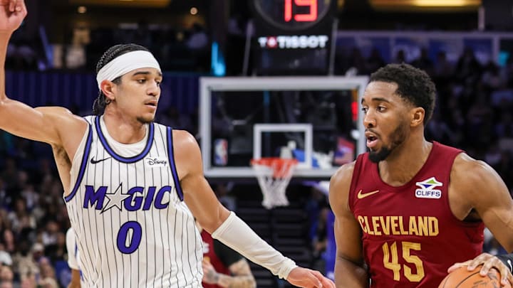 Cleveland Cavaliers guard Donovan Mitchell brings the ball up court against Orlando Magic guard Anthony Black.