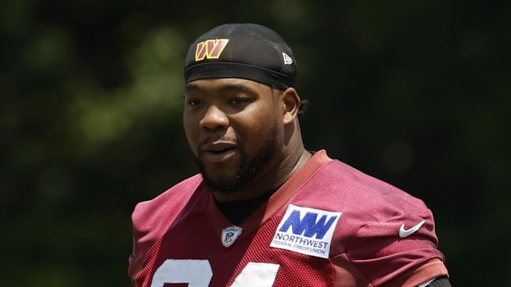 Washington Commanders defensive tackle Daron Payne stands on the field on day one of minicamp.