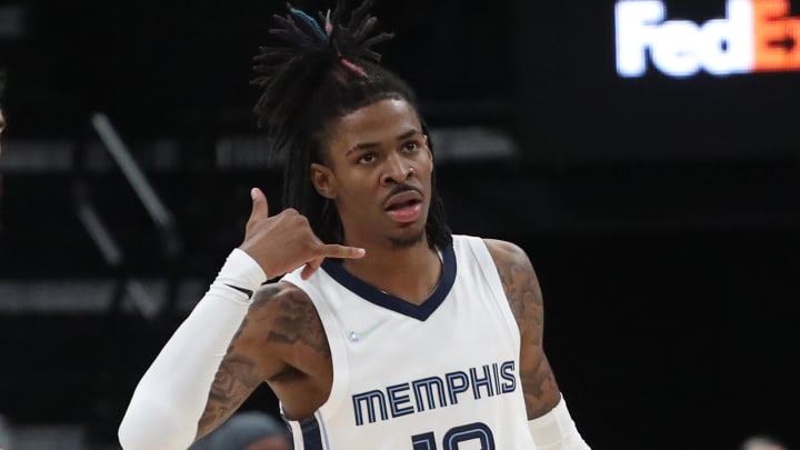Nov 1, 2021; Memphis, Tennessee, USA; Memphis Grizzles guard Ja Morant (12) makes a phone gesture after a made basket during the second half against the Denver Nuggets  at FedExForum. Mandatory Credit: Petre Thomas-USA TODAY Sports