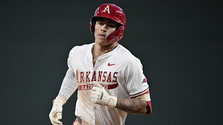 Arkansas shortstop Wehiwa Aloy rounds the bases after hitting a homer against the Michigan Wolverines. The Razorbacks won 8-6. 