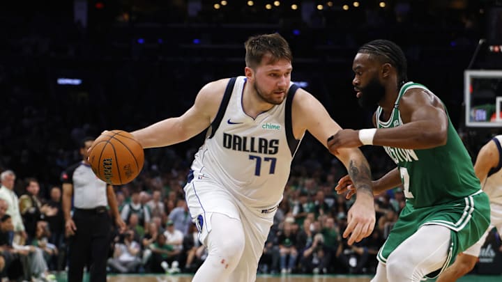 Jun 17, 2024; Boston, Massachusetts, USA; Dallas Mavericks guard Luka Doncic (77) dribbles the ball against Boston Celtics guard Jaylen Brown (7) during the second quarter in game five of the 2024 NBA Finals at TD Garden. Mandatory Credit: Peter Casey-Imagn Images