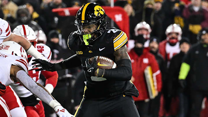 Nov 29, 2024; Iowa City, Iowa, USA; Iowa Hawkeyes running back Kaleb Johnson (2) runs the ball as Nebraska Cornhuskers defensive back DeShon Singleton (8) looks to make the tackle during the third quarter at Kinnick Stadium. Mandatory Credit: Jeffrey Becker-Imagn Images