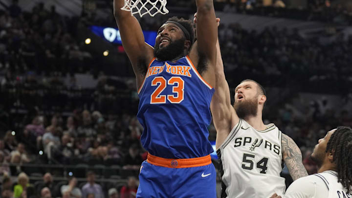 Mar 19, 2025; San Antonio, Texas, USA; New York Knicks center Mitchell Robinson (23) dunks ahead of San Antonio Spurs forward Sandro Mamukelashvili (54) during the second half at Frost Bank Center. Mandatory Credit: Scott Wachter-Imagn Images