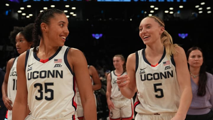Dec 7, 2024; Brooklyn, New York, USA; Connecticut Huskies guard Azzi Fudd (35) and Connecticut Huskies guard Paige Bueckers (5) celebrate after the game against the Louisville Cardinals at Barclays Center. Mandatory Credit: Lucas Boland-Imagn Images