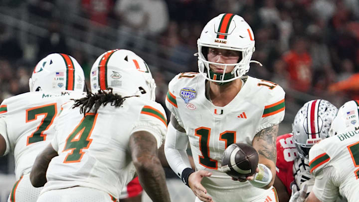 Dec 31, 2025; Arlington, TX, USA; Miami Hurricanes quarterback Carson Beck (11) hands off to running back Mark Fletcher Jr. (4) in the second quarter against the Ohio State Buckeyes during the 2025 Cotton Bowl and quarterfinal game of the College Football Playoff at AT&T Stadium. Mandatory Credit: Raymond Carlin III-Imagn Images