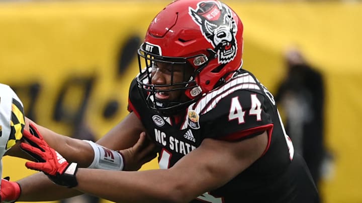 Dec 30, 2022; Charlotte, NC, USA; Maryland Terrapins quarterback Taulia Tagovailoa (3) scrambles as North Carolina State Wolfpack defensive lineman Brandon Cleveland (44) defends in the fourth quarter in the 2022 Duke's Mayo Bowl at Bank of America Stadium. Mandatory Credit: Bob Donnan-Imagn Images Dec 30, 2022; Charlotte, NC, USA; Maryland Terrapins quarterback Taulia Tagovailoa (3) scrambles as North Carolina State Wolfpack defensive lineman Brandon Cleveland (44) defends in the fourth quarter in the 2022 Duke's Mayo Bowl at Bank of America Stadium. Mandatory Credit: Bob Donnan-Imagn Images