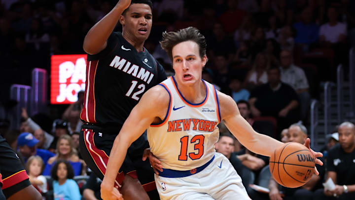 Oct 26, 2025; Miami, Florida, USA; New York Knicks guard Tyler Kolek (13) drives to the basket against Miami Heat guard Dru Smith (12) and center Bam Adebayo (13) during the third quarter at Kaseya Center. Mandatory Credit: Sam Navarro-Imagn Images