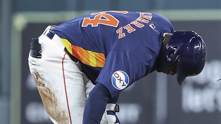 Sep 22, 2024; Houston, Texas, USA; Houston Astros left fielder Yordan Alvarez (44) holds his leg after hitting a double as Los Angeles Angels shortstop Zach Neto (9) looks on during the third inning at Minute Maid Park