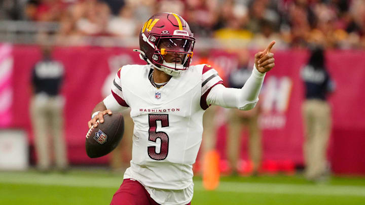 Commanders quarterback Jayden Daniels (5) looks for open receivers against the Cardinals during a game at State Farm Stadium in Glendale, Ariz., on Sunday, Sept. 29, 2024.