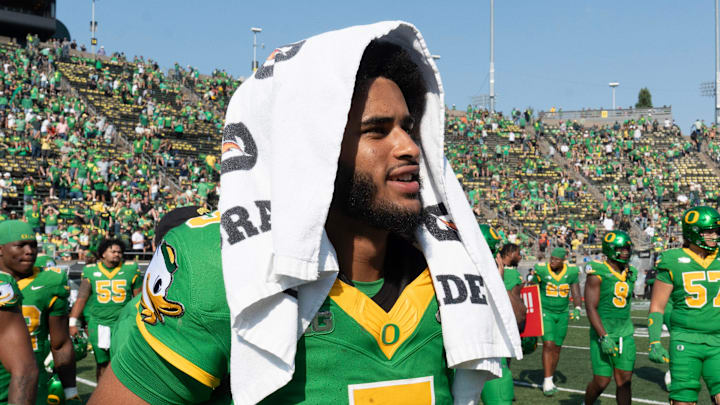 Oregon quarterback Dante Moore walks across the field to shake hands with Oklahoma State players after the win at Autzen.