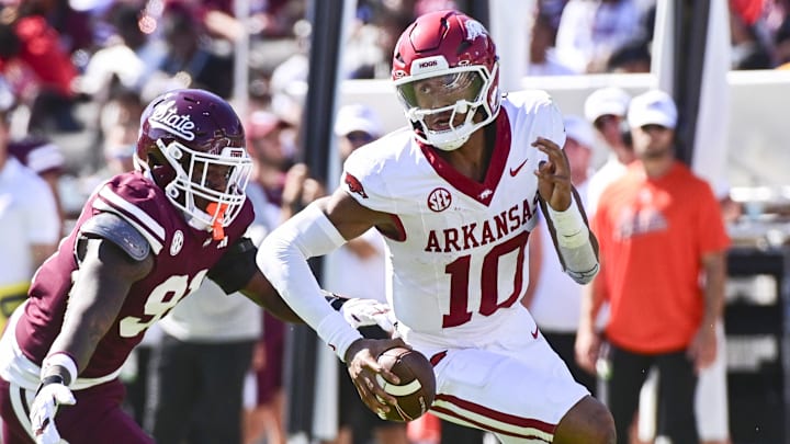 Arkansas Razorbacks quarterback Taylen Green (10) runs the ball while defended by Mississippi State Bulldogs defensive lineman Deonte Anderson (91) during the second quarter at Davis Wade Stadium at Scott Field. Arkansas Razorbacks quarterback Taylen Green (10) runs the ball while defended by Mississippi State Bulldogs defensive lineman Deonte Anderson (91) during the second quarter at Davis Wade Stadium at Scott Field.