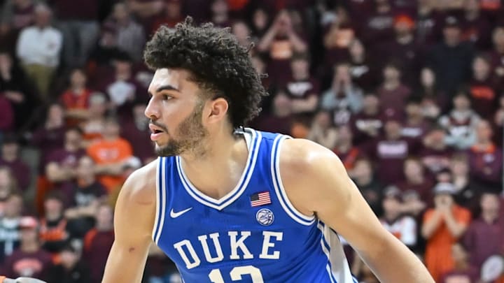 Jan 31, 2026; Blacksburg, Virginia, USA;  Duke Blue Devils forward Cameron Boozer (12) controls the ball as Virginia Tech Hokies forward Tobi Lawal (1) defends during the first half at Cassell Coliseum. Mandatory Credit: Brian Bishop-Imagn Images