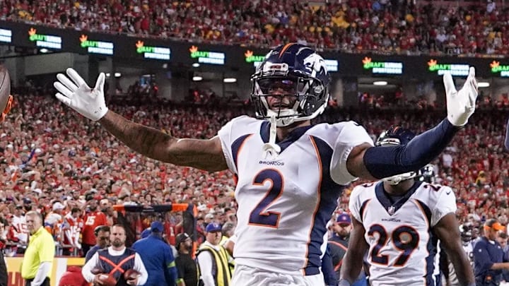Oct 12, 2023; Kansas City, Missouri, USA; Denver Broncos safety Justin Simmons (31) and cornerback Pat Surtain II (2) and cornerback Damarri Mathis (27) celebrate after Simmon   s interception against the Kansas City Chiefs during the first half at GEHA Field at Arrowhead Stadium. Mandatory Credit: Denny Medley-Imagn Images