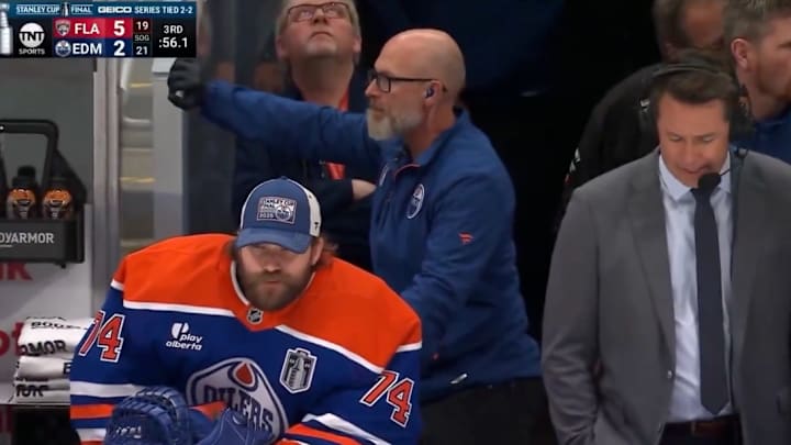 Edmonton Oilers goalie Stuart Skinner sits next to TNT's between-the-benches analyst Brian Boucher during Game 5 of the Stanley Cup Final.