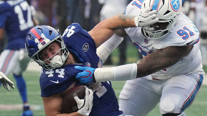 Sep 27, 2026; East Rutherford, New Jersey, USA;  New York Giants running back Cam Skattebo (44) runs with the ball against Tennessee Titans defensive end John Franklin-Myers (91) during the second quarter at MetLife Stadium.  Mandatory Credit: Robert Deutsch-Imagn Images