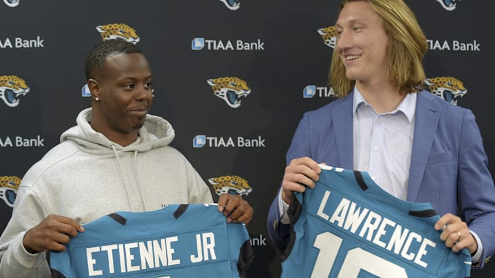 Former Clemson teammates Travis Etienne and Trevor Lawrence and now Jacksonville Jaguars teammates with their new jerseys during an introductory press conference Friday, April 30, 2021, in Jacksonville, Fla. (Bob Self/The Florida Times-Union)