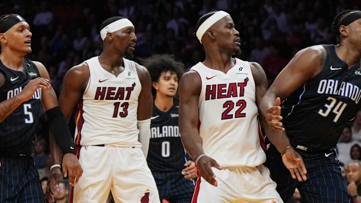 Oct 23, 2024; Miami, Florida, USA;  Orlando Magic center Wendell Carter Jr. (34) reaches for a rebound as Miami Heat forward Jimmy Butler (22) looks on during the first half at Kaseya Center. Mandatory Credit: Jim Rassol-Imagn Images