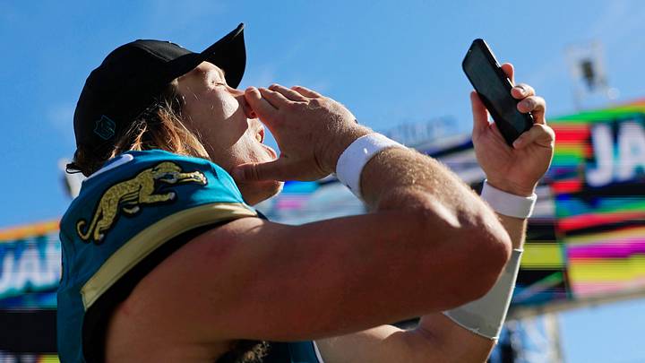 Jacksonville Jaguars quarterback Trevor Lawrence (16) makes a social media post with a hearty, “Duuuval!” while walking off the field after the game of an NFL football matchup at EverBank Stadium on Sunday, Sept. 27, 2026, in Jacksonville, Fla. 