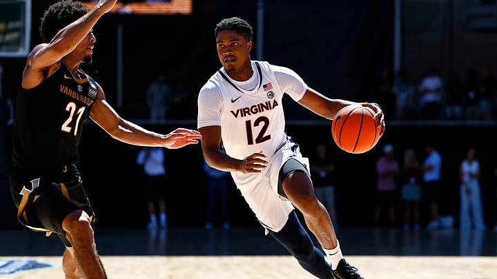 Virginia's Elijah Gertrude maneuvers past a Vanderbilt defender. Virginia's Elijah Gertrude maneuvers past a Vanderbilt defender.