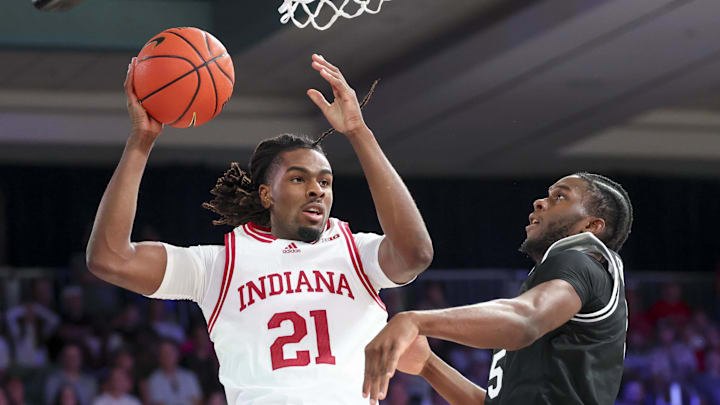 Indiana forward Mackenzie Mgbako (21) looks to pass as Providence forward Oswin Erhunmwunse (55) defends during the Battle 4 Atlantis. Indiana forward Mackenzie Mgbako (21) looks to pass as Providence forward Oswin Erhunmwunse (55) defends during the Battle 4 Atlantis.