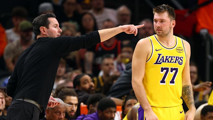 Oct 14, 2025; Phoenix, Arizona, USA; Los Angeles Lakers guard Luka Doncic (77) with head coach JJ Redick against the Phoenix Suns during an NBA preseason game at Mortgage Matchup Center. Mandatory Credit: Mark J. Rebilas-Imagn Images

