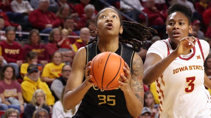 Jan 31, 2026; Ames, Iowa, USA; UCF Knights center Khyala Ngodu (35) beats Iowa State Cyclones forward Alisa Williams (3) to the basket during the second half at James H. Hilton Coliseum. Mandatory Credit: Reese Strickland-Imagn Images