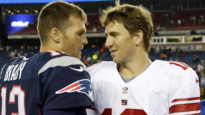 Aug 29, 2013; Foxborough, MA, USA; New England Patriots quarterback Tom Brady (12) and New York Giants quarterback Eli Manning (10) meet on the field after the game Gillette Stadium. The Patriots defeated the Giants 28-20. Mandatory Credit: David Butler II-Imagn Images