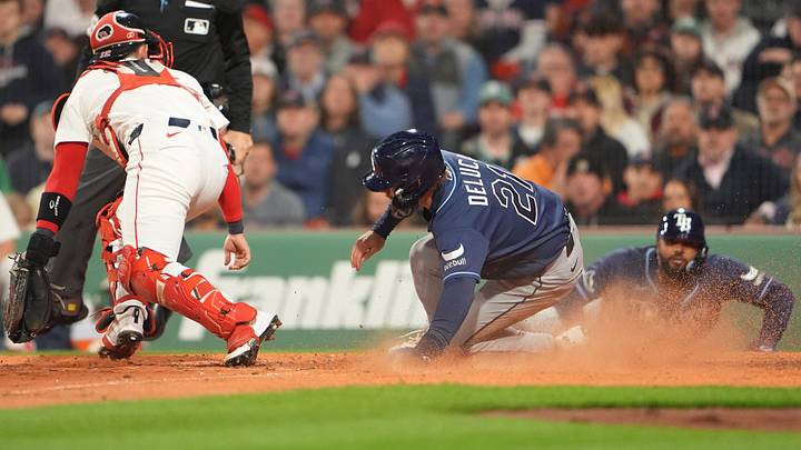 May 7, 2026; Boston, Massachusetts, USA; Tampa Bay Rays right fielder Jonny DeLuca (21) slides safely into home plate on Tampa Bay Rays left fielder Chandler Simpson (14) (not pictured) RBI single against the Boston Red Sox during the sixth inning at Fenway Park.