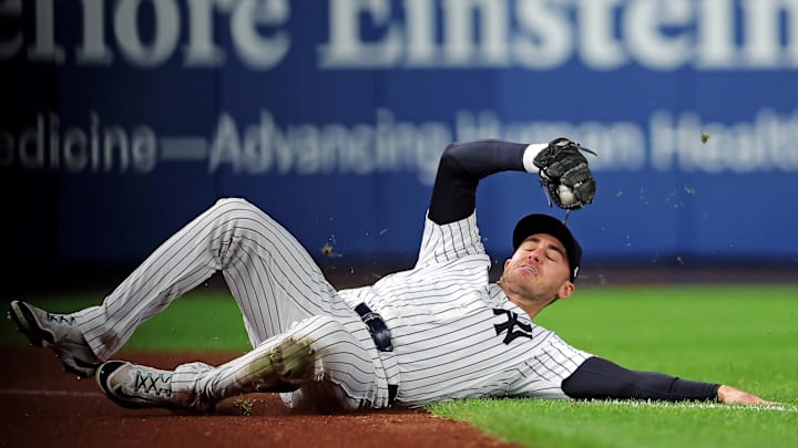 Oct 8, 2025; Bronx, New York, USA; New York Yankees left fielder Cody Bellinger (35) slides to makes a catch during the first inning against the Toronto Blue Jays during game four of the ALDS round for the 2025 MLB playoffs at Yankee Stadium. Mandatory Credit: Brad Penner-Imagn Images