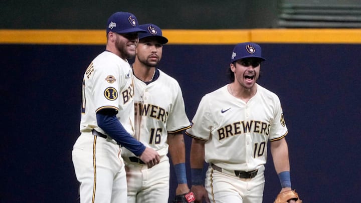 Milwaukee Brewers left fielder Brandon Lockridge (20), Milwaukee Brewers center fielder Blake Perkins (16) and Milwaukee Brewers right fielder Sal Frelick (10) celebrate the final out after beating the Chicago Cubs 7-3 during the National League Division Series game at American Family Field in Milwaukee, Wisconsin on Oct. 6, 2025.