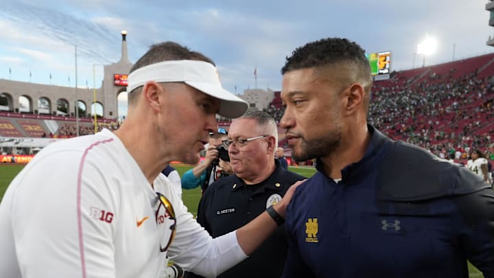 Nov 30, 2024; Los Angeles, California, USA; Southern California Trojans head coach Lincoln Riley and Notre Dame Fighting Irish head coach Marcus Freeman shake hands after the game at United Airlines Field at Los Angeles Memorial Coliseum. Mandatory Credit: Kirby Lee-Imagn Images