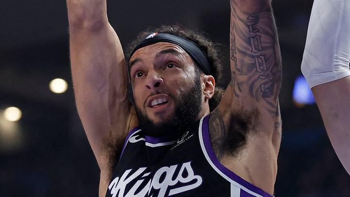 Oct 28, 2025; Oklahoma City, Oklahoma, USA;Sacramento Kings guard Devin Carter (22) dunks against Oklahoma City Thunder guard Alex Caruso (9) during the second quarter at Paycom Center. Mandatory Credit: Alonzo Adams-Imagn Images