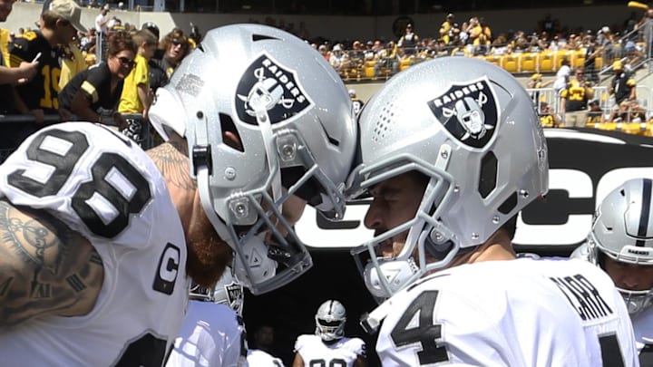 Sep 19, 2021; Pittsburgh, Pennsylvania, USA;  Las Vegas Raiders defensive end Maxx Crosby (98) and quarterback Derek Carr (4) prepare to take the field to play the Pittsburgh Steelers at Heinz Field. Mandatory Credit: Charles LeClaire-Imagn Images