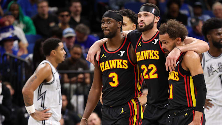 Atlanta Hawks forward Larry Nance Jr. (22) is helped off the court by guard Trae Young (11) and guard Caris LeVert (3) against the Orlando Magic in the fourth quarter at Kia Center.