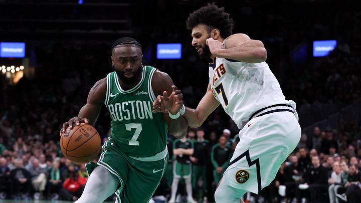Mar 2, 2025; Boston, Massachusetts, USA; Boston Celtics forward Jaylen Brown (7) drives to the basket defended by Denver Nuggets guard Jamal Murray (27) during the second half at TD Garden. Mandatory Credit: Paul Rutherford-Imagn Images