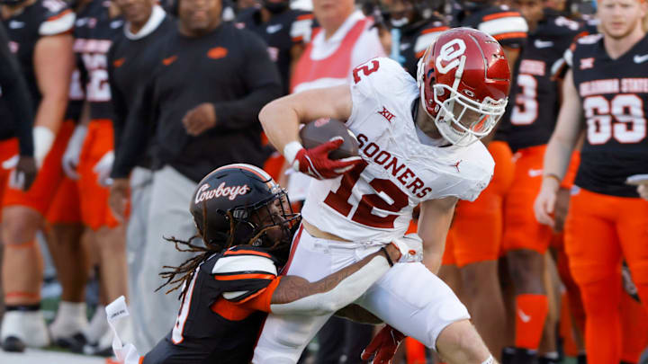 Oklahoma Sooners wide receiver Drake Stoops (12) is brought down by Oklahoma State Cowboys cornerback Kale Smith (10) after a reception during a Bedlam college football game between the Oklahoma State University Cowboys (OSU) and the University of Oklahoma Sooners (OU) at Boone Pickens Stadium in Stillwater, Okla., Saturday, Nov. 4, 2023. 