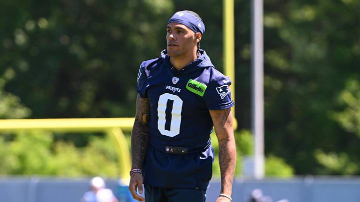 Jun 9, 2026; Foxborough, MA, USA; New England Patriots cornerback Christian Gonzalez (0) looks on before the start of drills at minicamp at Gillette Stadium. Mandatory Credit: Eric Canha-Imagn Images