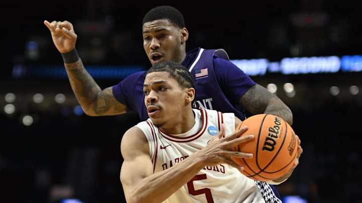 Arkansas Razorbacks guard Darius Acuff Jr. (5) drives against High Point Panthers forward Cam'ron Fletcher (11) in the second half during a second round game of the men's 2026 NCAA Tournament at Moda Center.