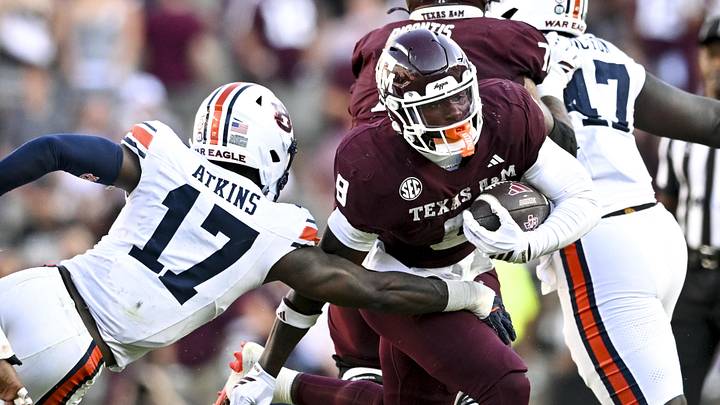 Texas A&M Aggies running back Le'Veon Moss runs the ball as Auburn Tigers linebacker Xavier Atkins attempts to tackle during the third quarter at Kyle Field. Texas A&M Aggies running back Le'Veon Moss runs the ball as Auburn Tigers linebacker Xavier Atkins attempts to tackle during the third quarter at Kyle Field.