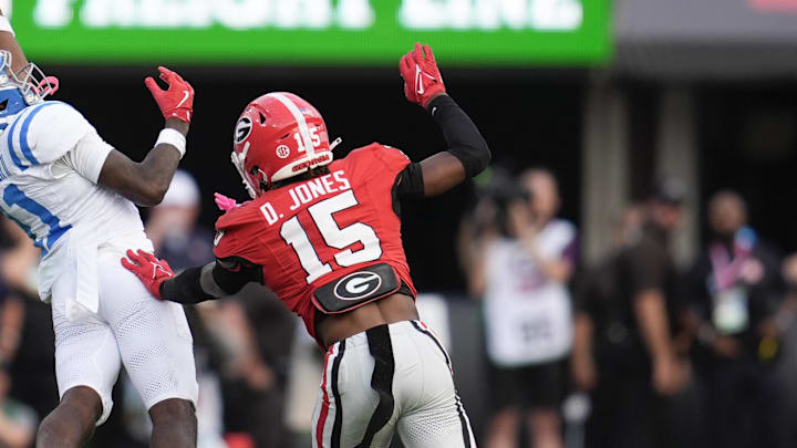 Oct 18, 2025; Athens, Georgia, USA;  Mississippi Rebels wide receiver Deuce Alexander (11) reaches for the ball against Georgia Bulldogs defensive back Demello Jones (15) during the second half of the game at Sanford Stadium. Mandatory Credit: Dale Zanine-Imagn Images