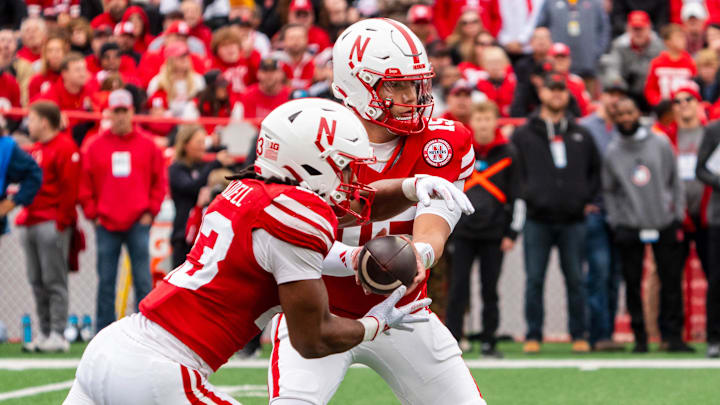 Nov 2, 2024; Lincoln, Nebraska, USA; Nebraska Cornhuskers quarterback Dylan Raiola hands the ball off to running back Dante Dowdell against the UCLA Bruins during the first quarter at Memorial Stadium.