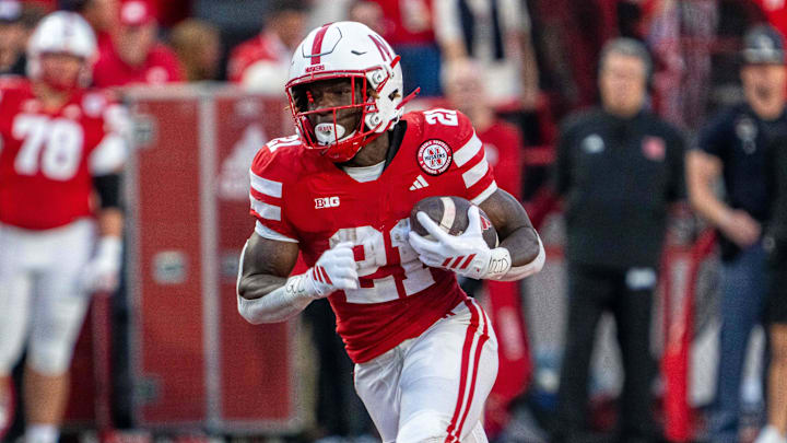 Sep 6, 2025; Lincoln, Nebraska, USA; Nebraska Cornhuskers running back Emmett Johnson (21) runs against the Akron Zips during the second quarter at Memorial Stadium. Mandatory Credit: Dylan Widger-Imagn Images