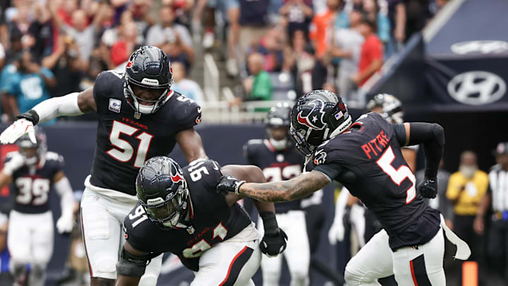 Sep 29, 2024; Houston, Texas, USA;  Houston Texans defensive tackle Folorunso Fatukasi (91) and teammates react after stopping Jacksonville Jaguars quarterback Trevor Lawrence (16) on fourth down in the second half at NRG Stadium. Mandatory Credit: Thomas Shea-Imagn Images