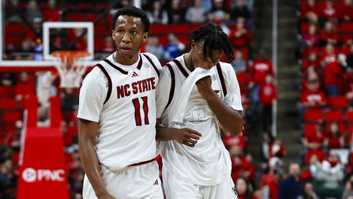 Dec 6, 2025; Raleigh, North Carolina, USA; NC State Wolfpack guard Quadir Copeland (11) consoles guard Jr. Paul McNeil (2) during the second half of the game against UNC Asheville Bulldogs at Lenovo Center. Mandatory Credit: Jaylynn Nash-Imagn Images